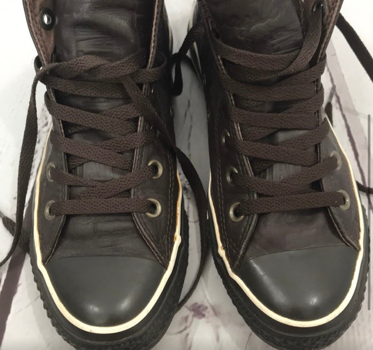 Converse brown on brown leather sneakers.