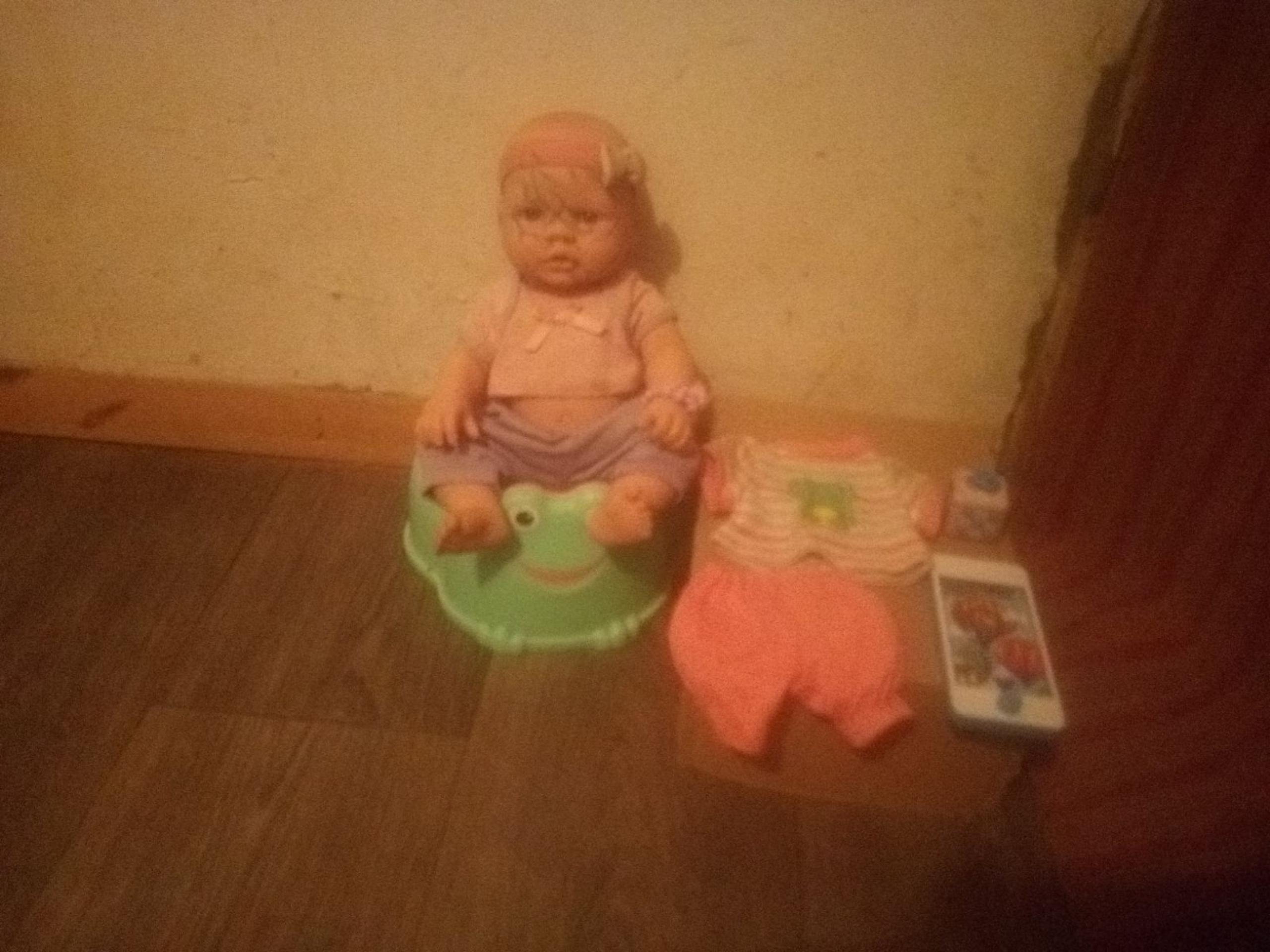 A doll and a toy 2 and a close green hea
