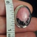 10k white gold rhodonite ring size 5 1/4. It measures between 5.5 and 5.25 on my