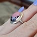10k white gold rhodonite ring size 5 1/4. It measures between 5.5 and 5.25 on my