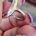 10k white gold rhodonite ring size 5 1/4. It measures between 5.5 and 5.25 on my