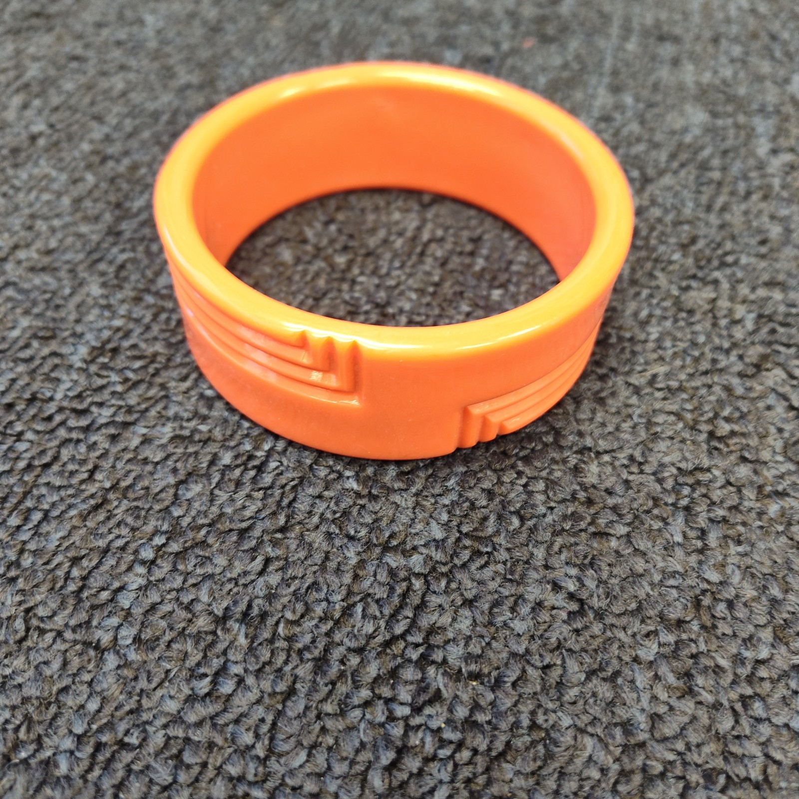1930's orange carved bakelite bangle bracelet
