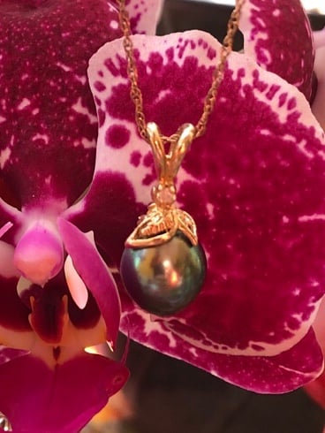 Black pearl, diamond gold pendant, and chain