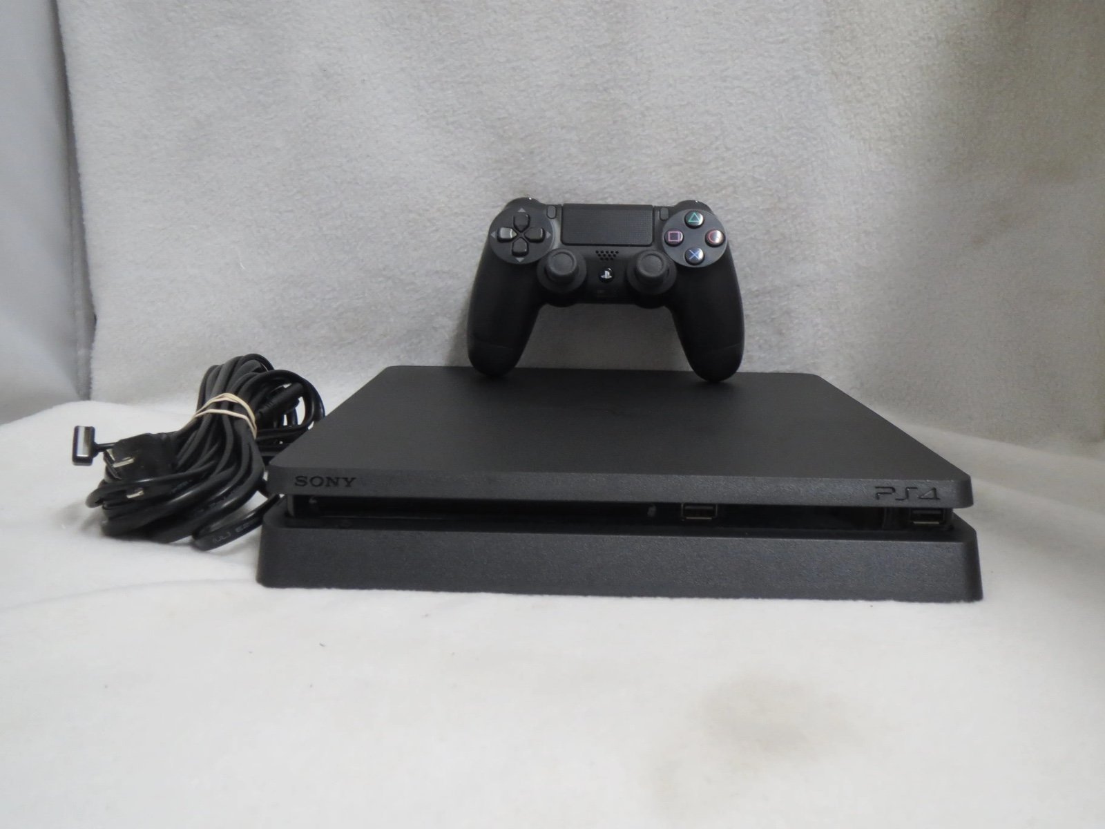 PlayStation 4 Slim 1TB Black including controller, Fifa 23, and NBA2K23
