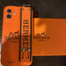 H Logo IPHONE 12 CASE SILICONE With Strap And Key Ring Orange Color