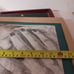 The image is a pencil sketch of a woman's face. She is looking at the viewer wit