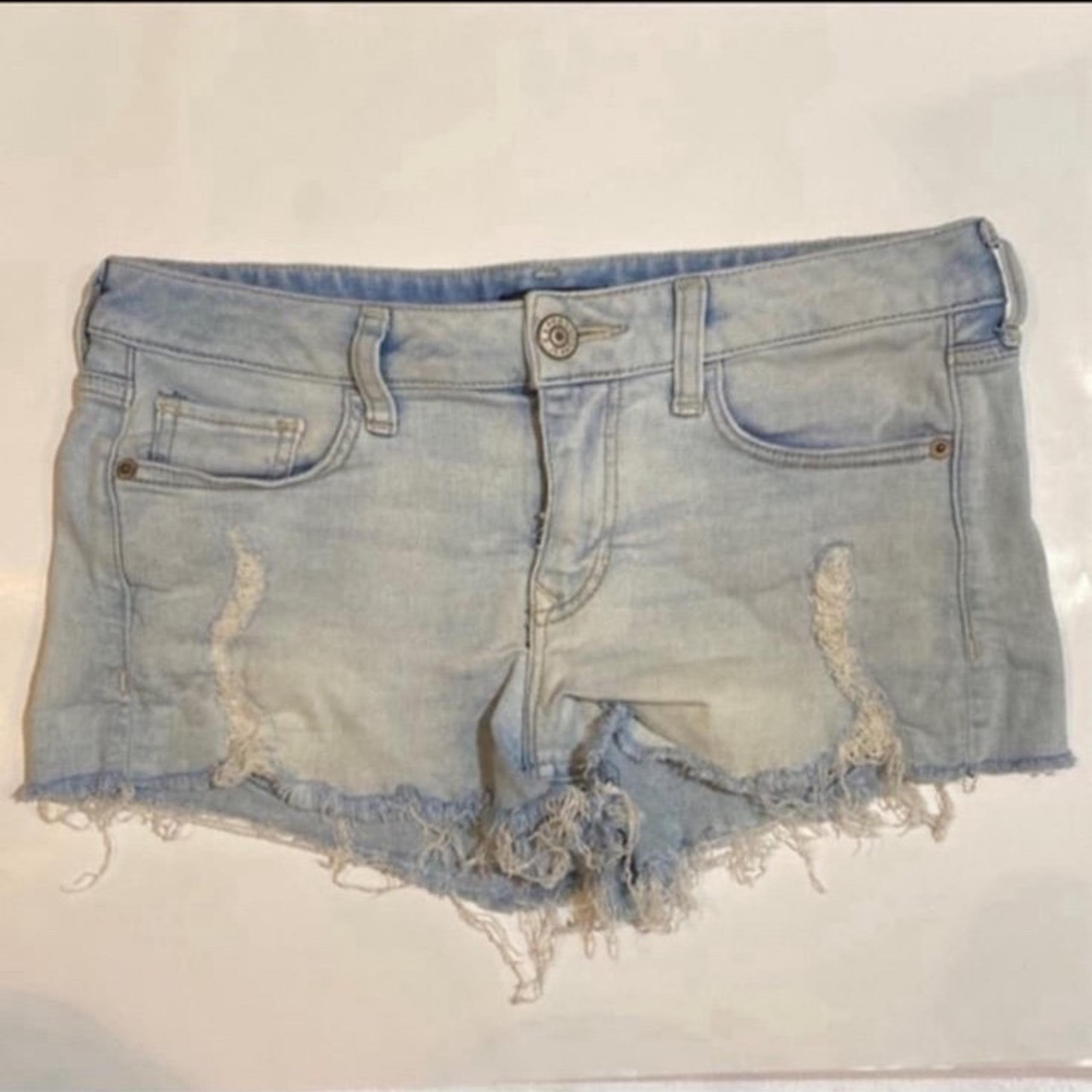 Express ultimate stretch shortie low rise light denim distressed cut off shorts