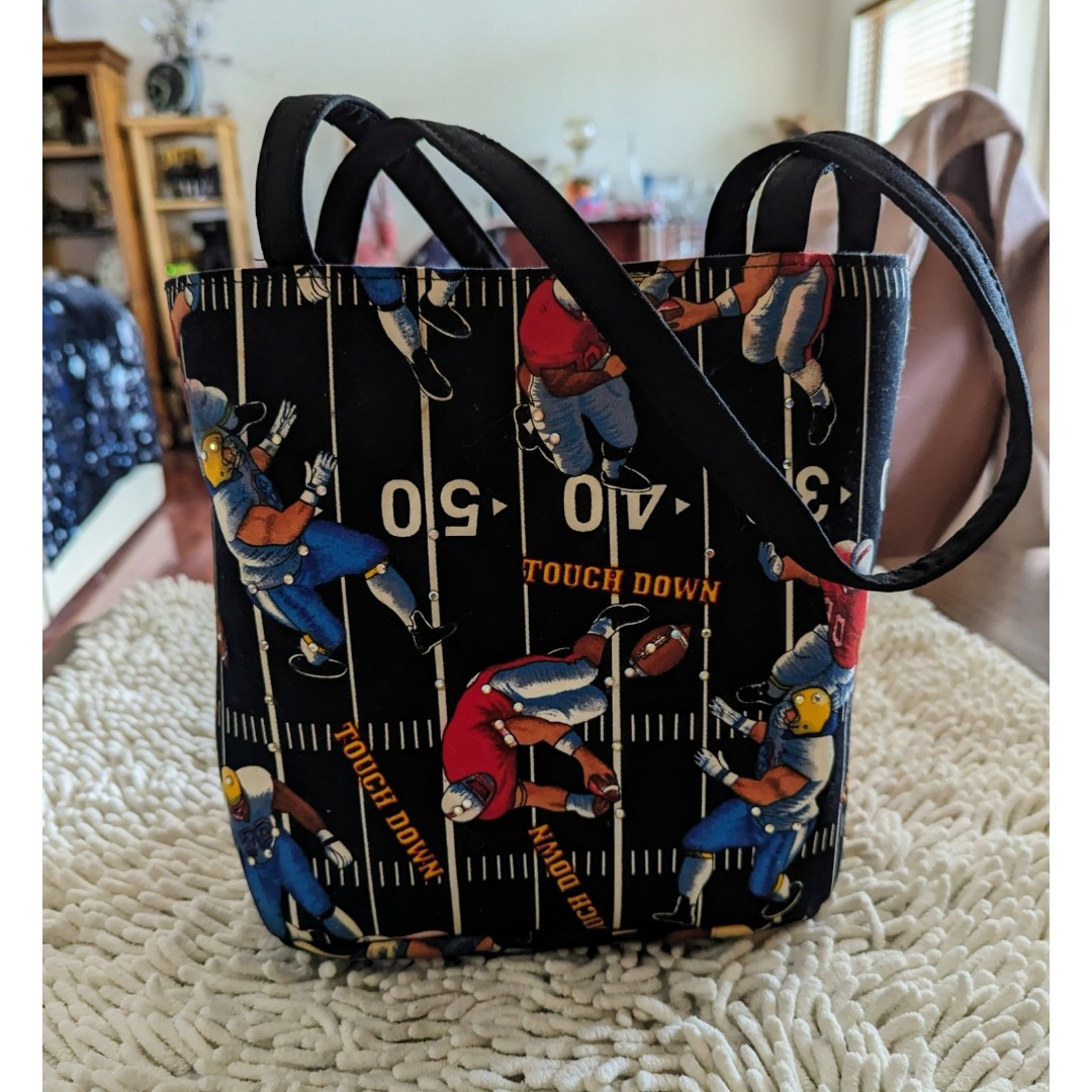 Black football touchdown bucket tote bag