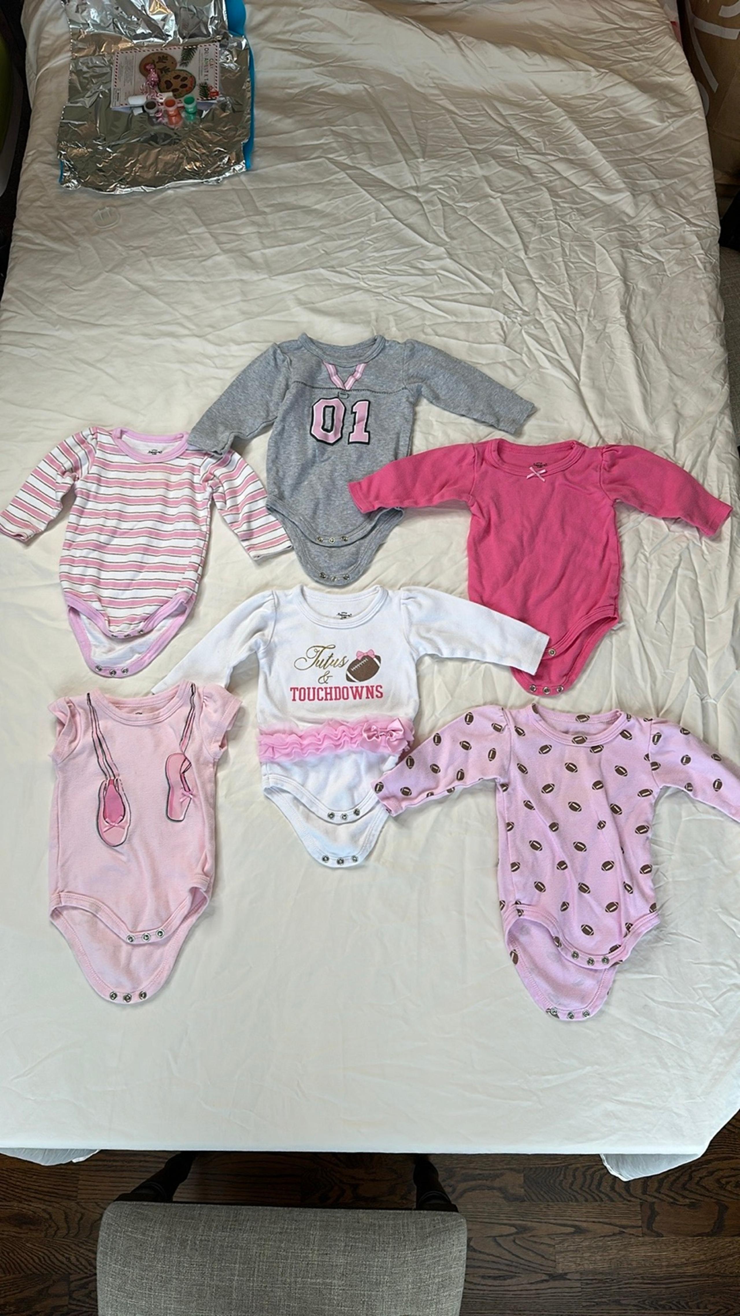 Bundle of 6 onesies. All Little Treasures brand, five long sleeve and one short