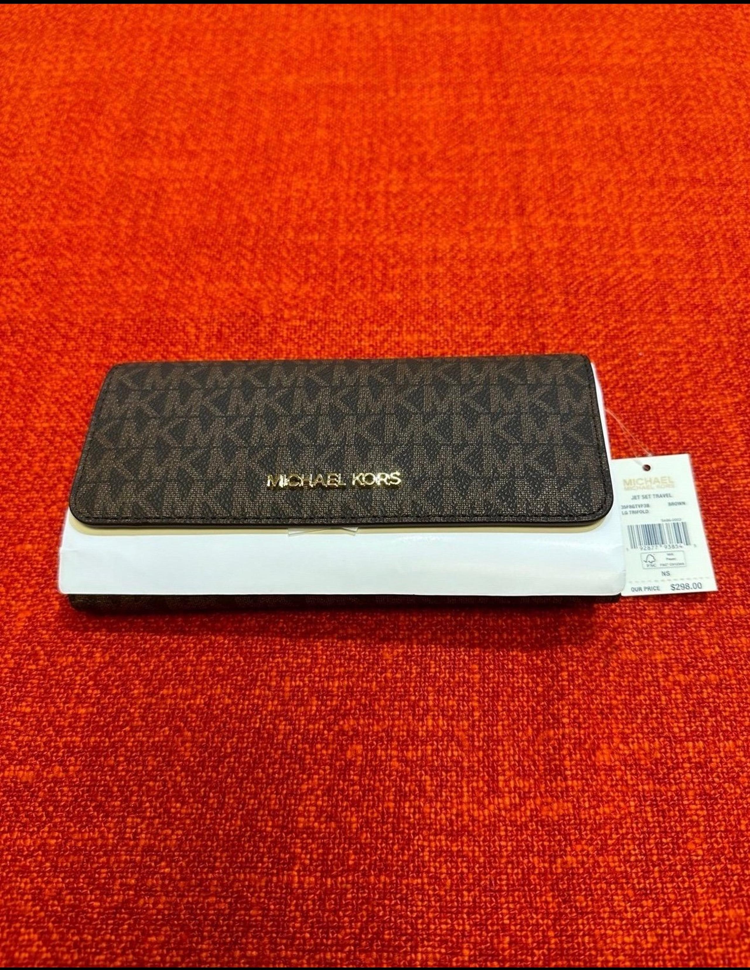 Authentic Michael Kors Trifold wallet  in signature monogram canvas