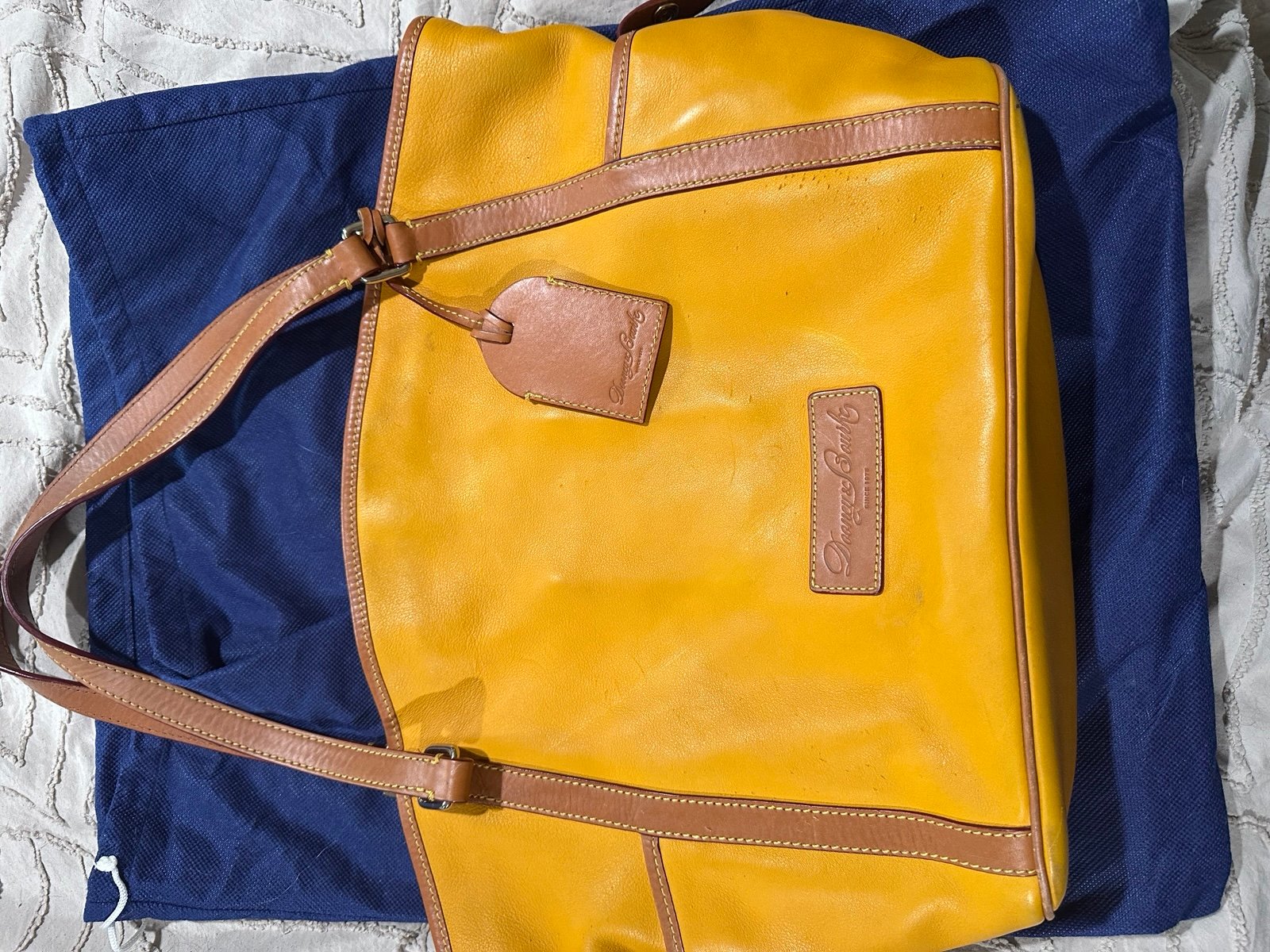Dooney & Bourke Travel Bag/Tote. Yellow leather Exterior.