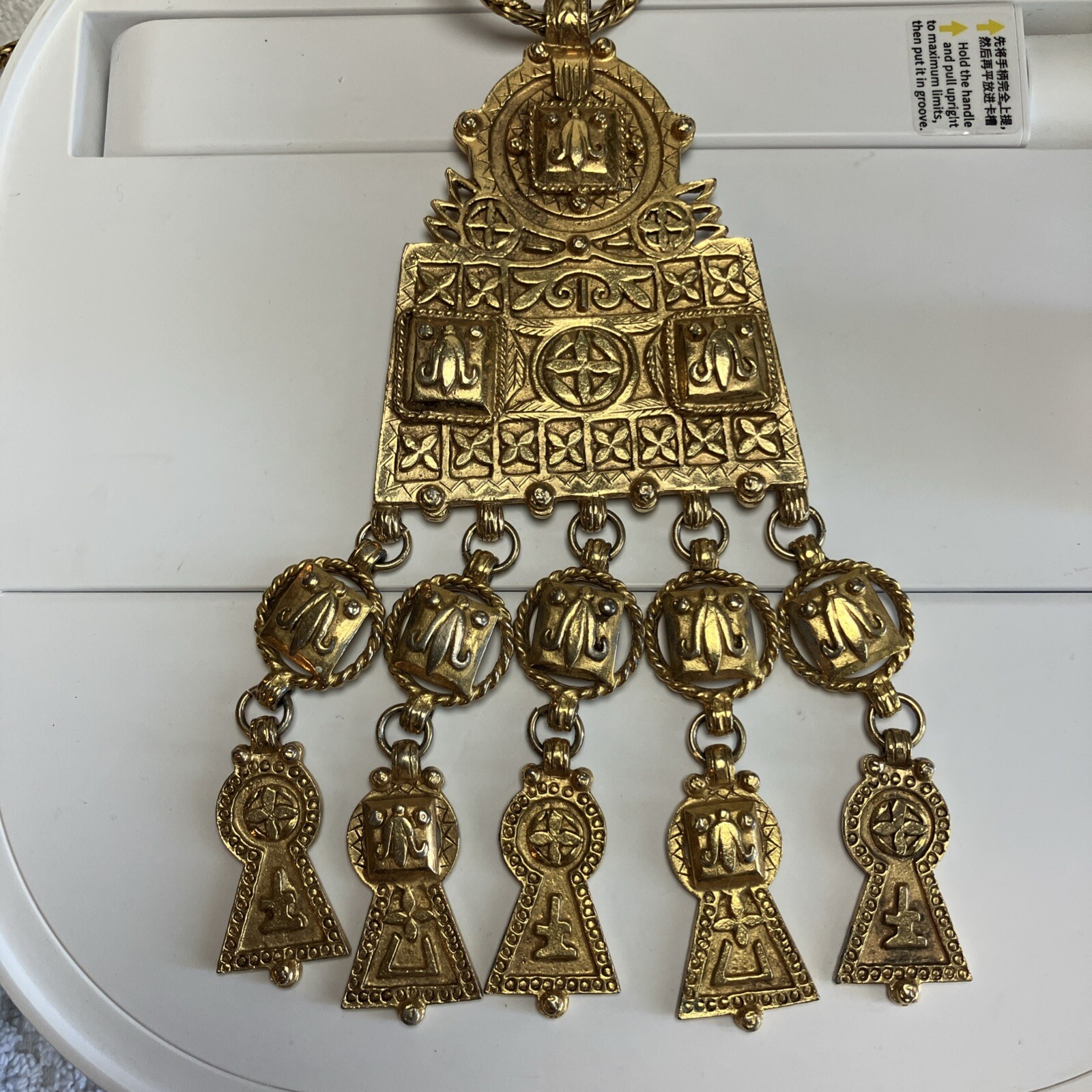 Kenneth Lane necklace pendant featuring an Aztec or Egyptian inspired design