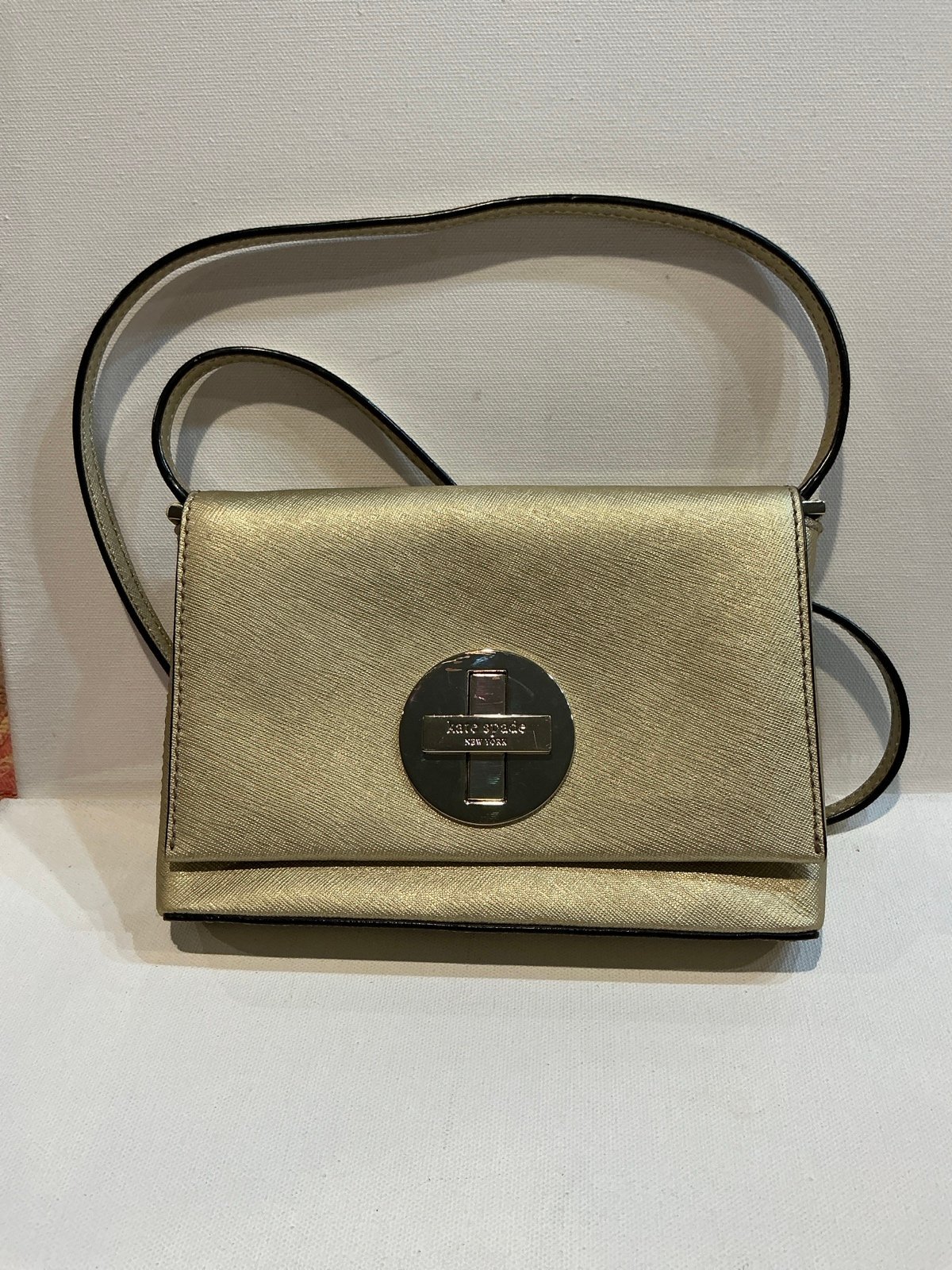 Kate Spade New York Saffiano Leather Gold Crossbody Bag with Turnlock.