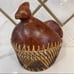 Hand woven rattan wicker chicken basket with wooden chicken head and tail.