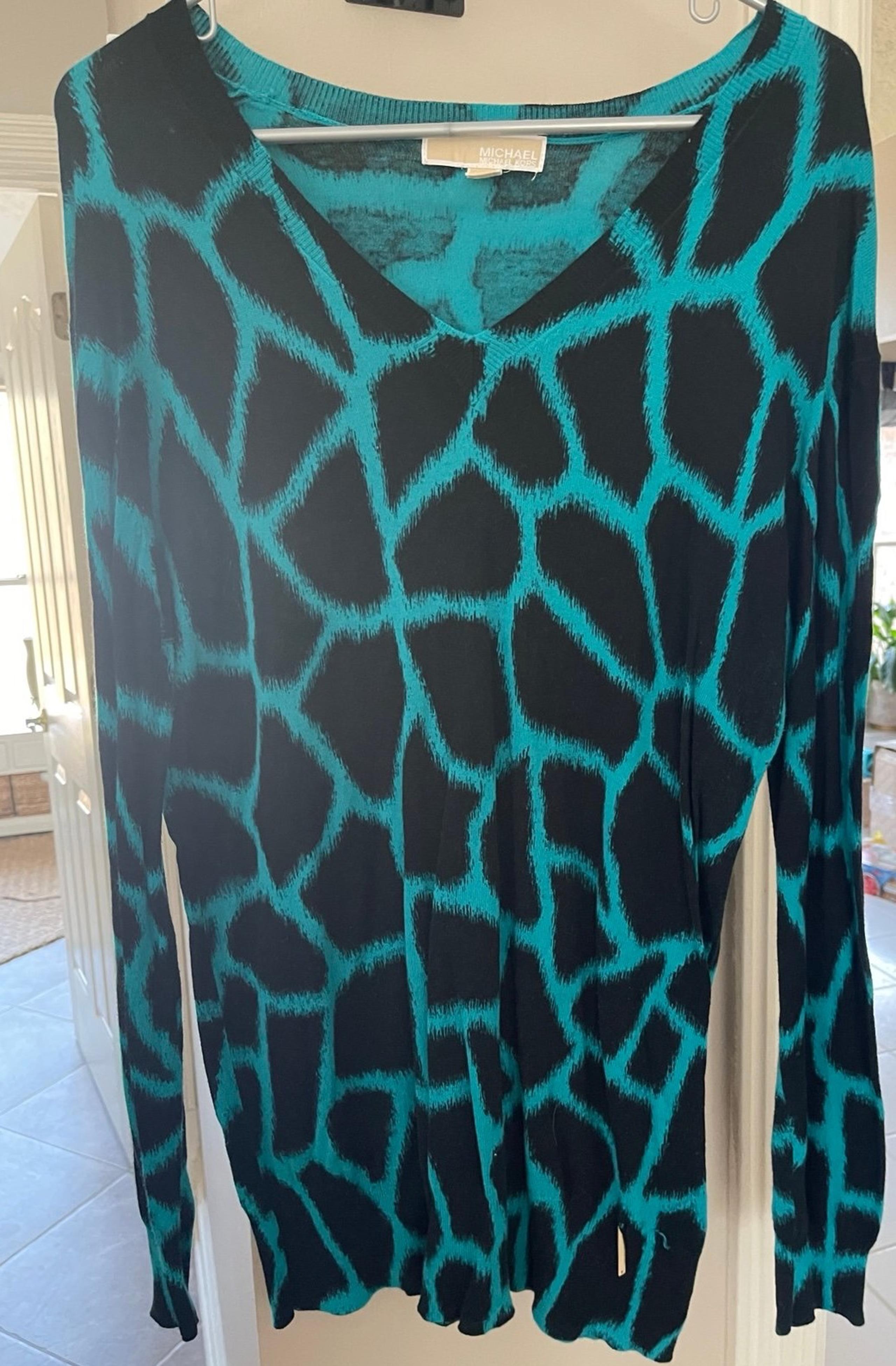 Sweater thinner and comfy. Not bulky teal and black animal print