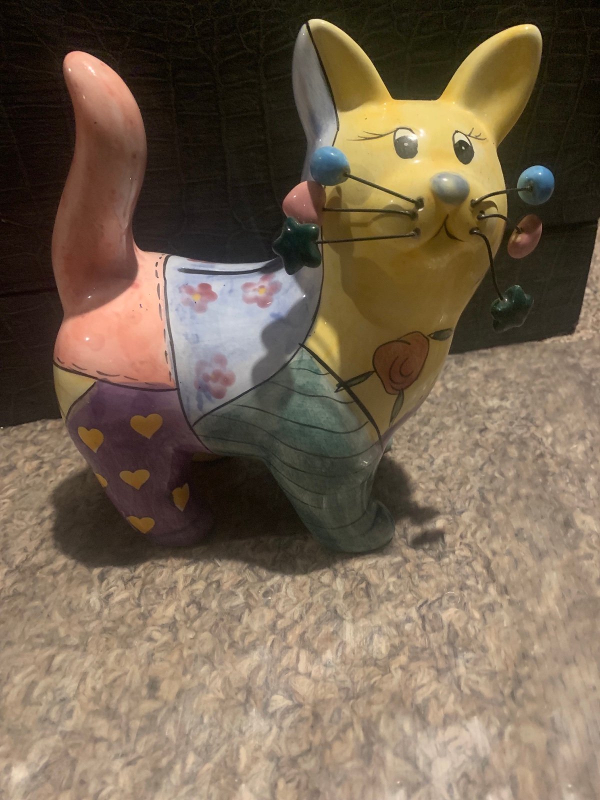 Alice in Wonderland esque cat piggy bank artsy whimsical abstract craft style.