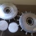 Two antique Volvo 240 hubcaps