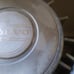 Two antique Volvo 240 hubcaps