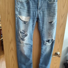 Distressed buckle jeans