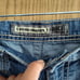 Distressed buckle jeans