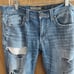 Distressed buckle jeans