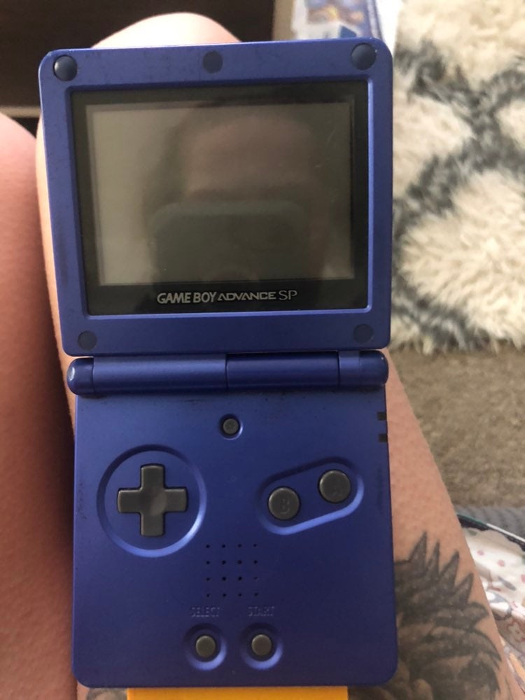 Gameboy Advance SP in cobalt with pokemon yellow game.