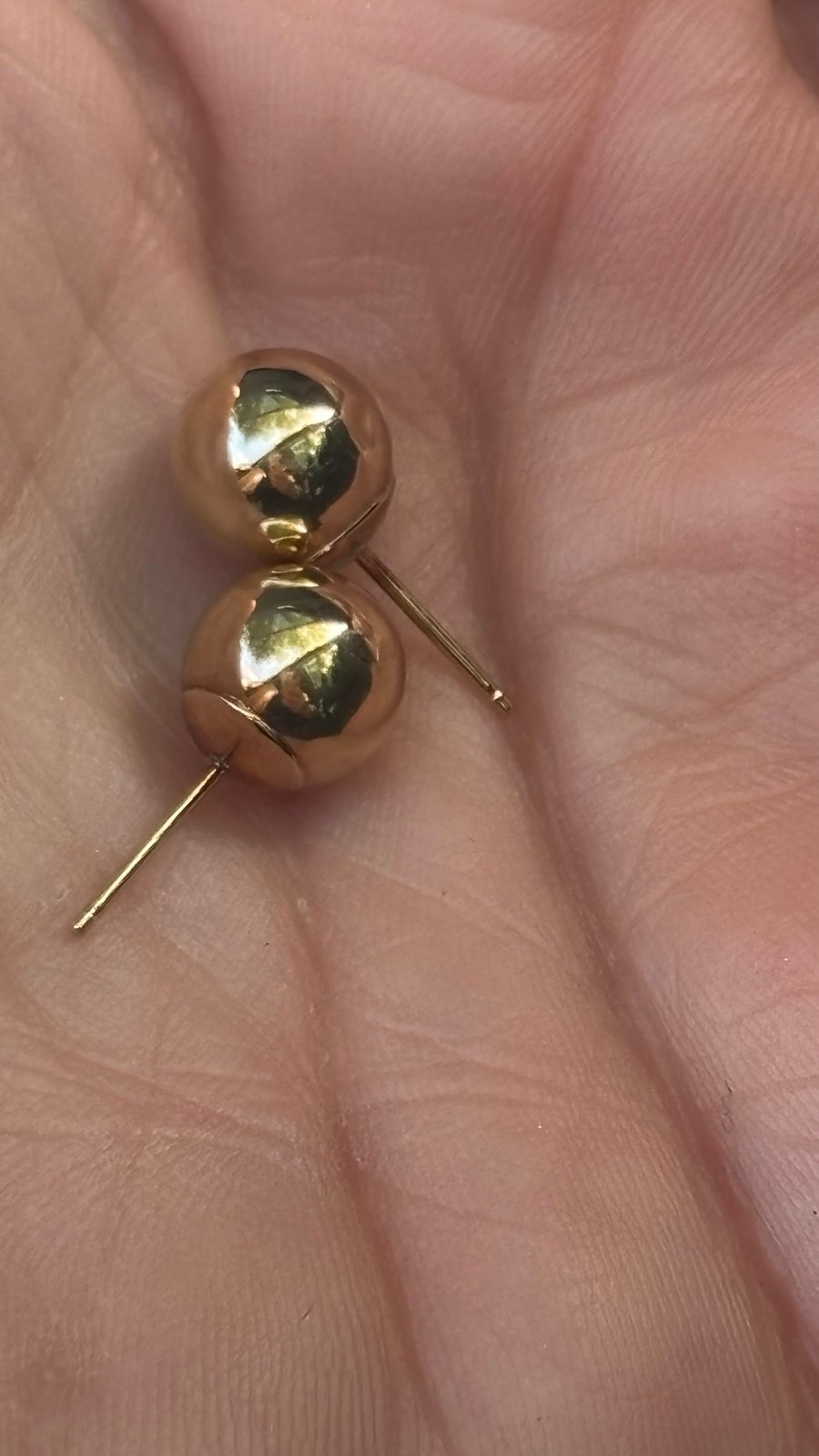 14 karat yellow gold 12 mm ball stud earrings. Do you have a very tiny dent as t