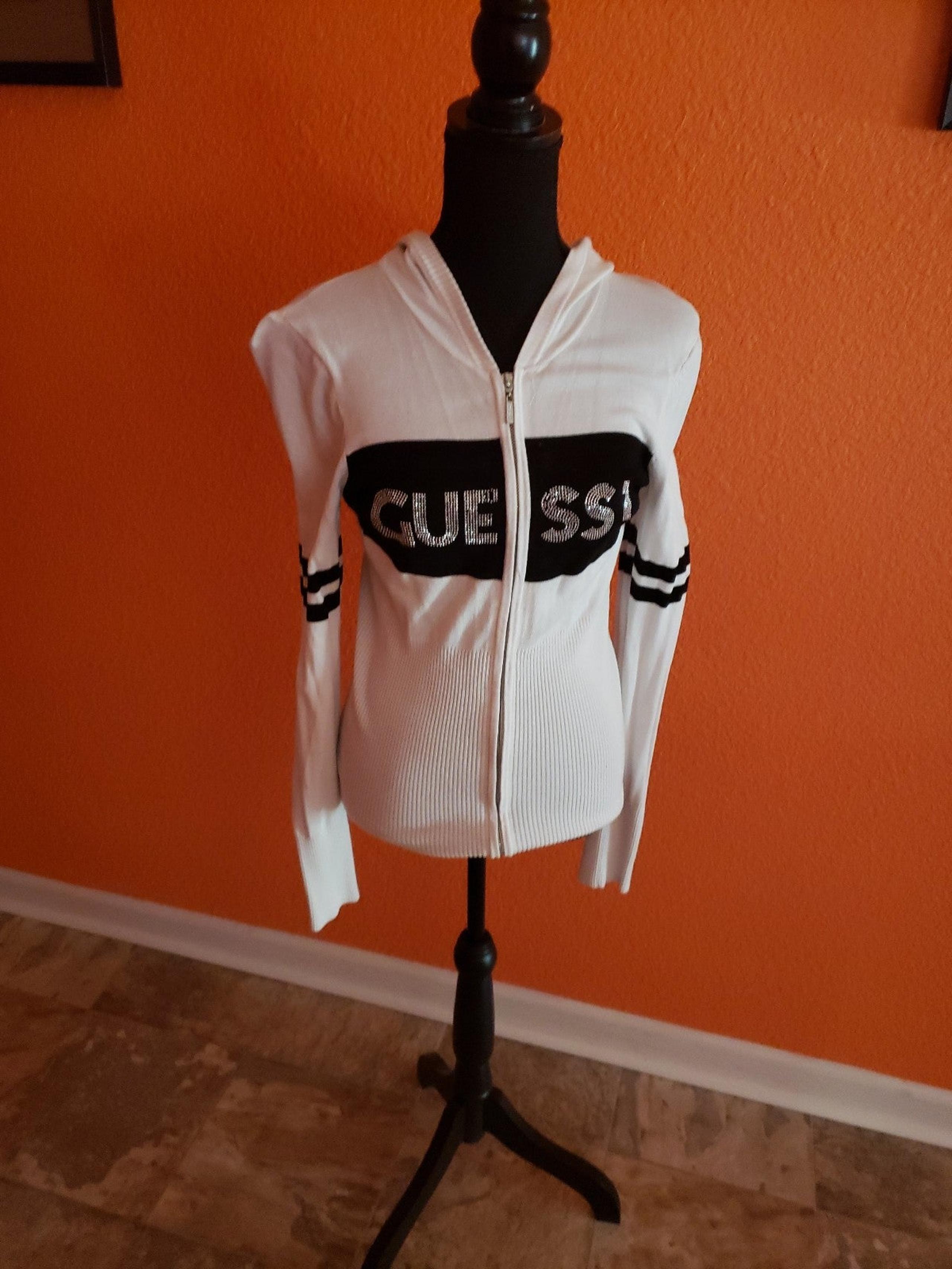 Gently used Junior's Guess zip up hooded  sweater. Size L.