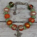 Orange Hand-Painted Glass Beads with Silver and Green Rhinestones and Bee Charm