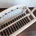 White wicker magazine rack basket