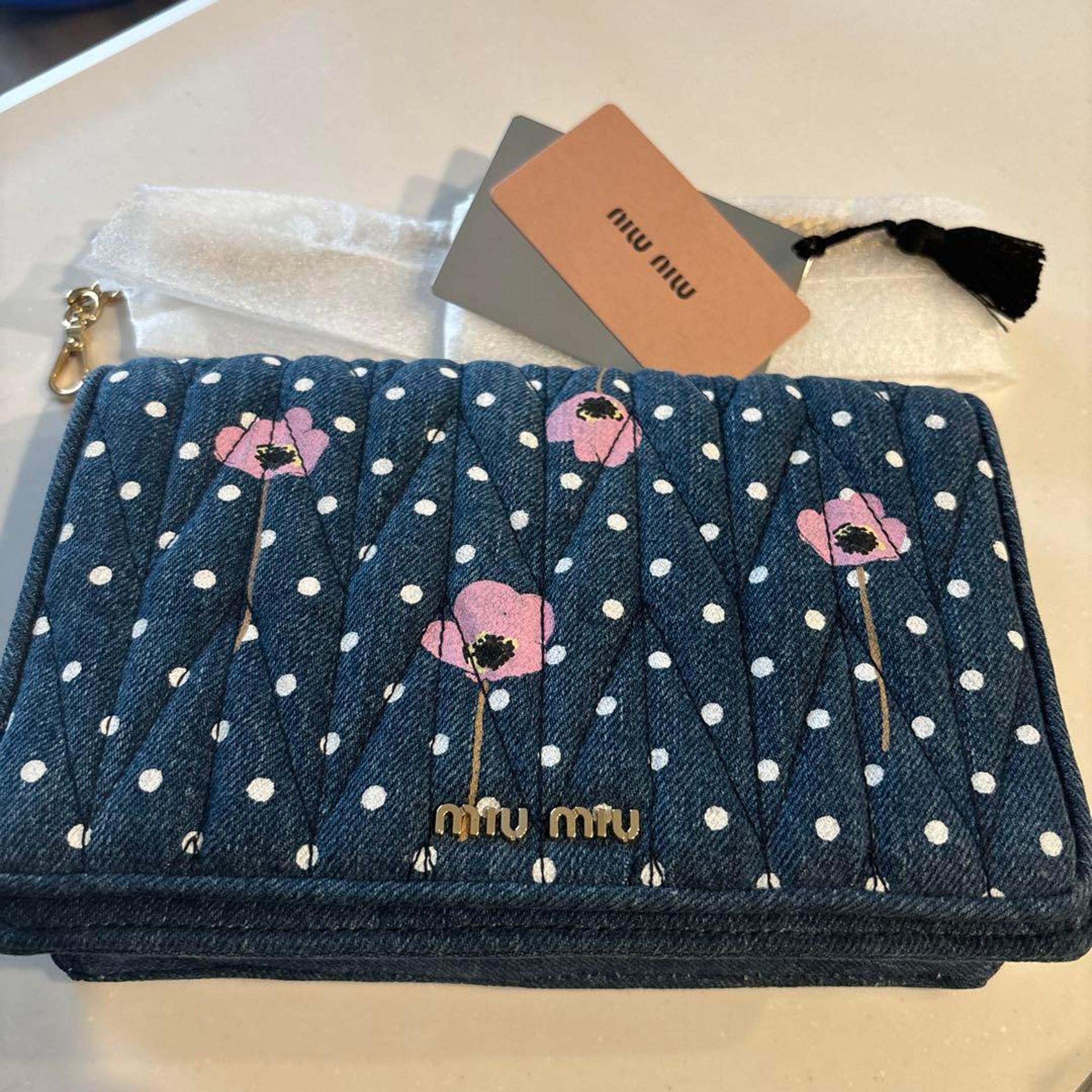 Miu Miu shoulder bag with chain, denim, polka dots, and floral pattern.