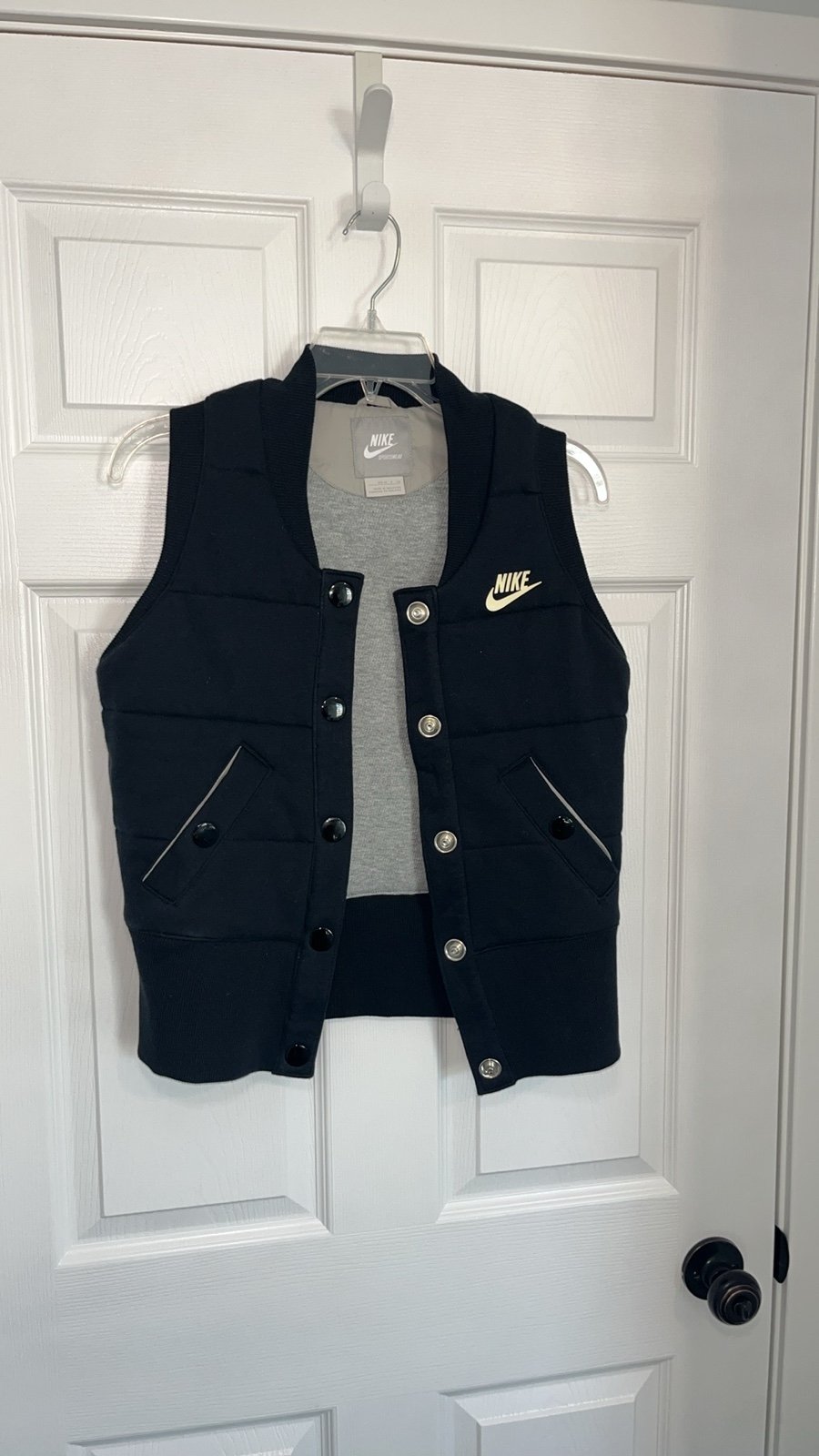 Nike Sportswear Black Puffer Vest. Stylish black puffer vest with snap closure.