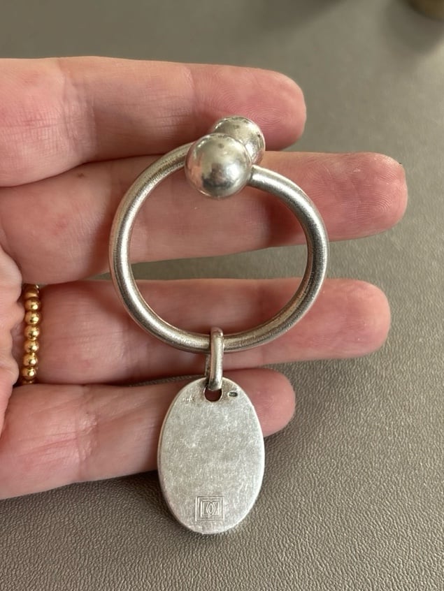Sterling silver keychain with bead closure.