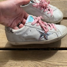 Woman’s golden goose shoes