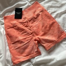 Huxley Neon Coral sun fade shorts