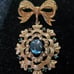 Gorgeous Golden Bow with Blue Stones