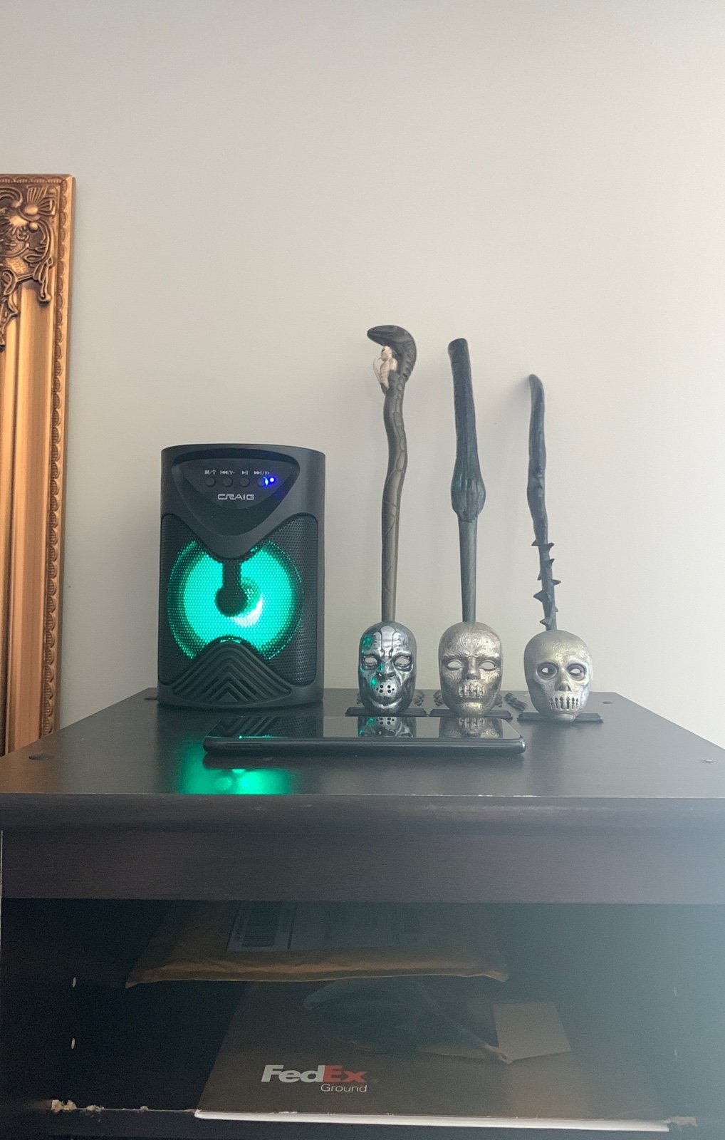 cell phones and Bluetooth speaker with Harry Potter wands