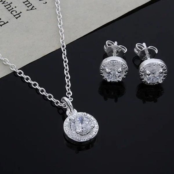 The Dainty Solitaire pendant necklace and stud earrings set in sterling silver