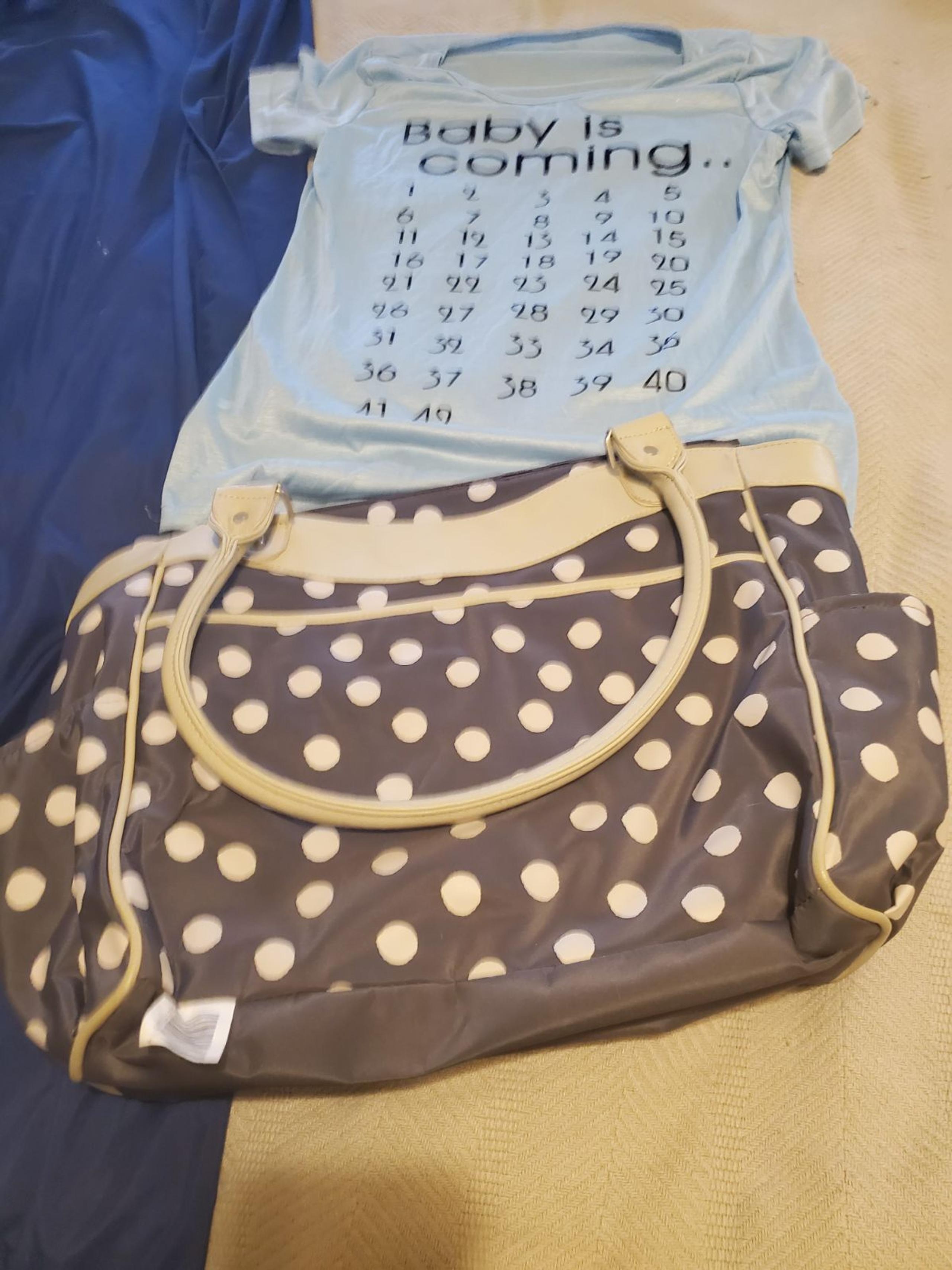 diaper bag and shirt baby coming
