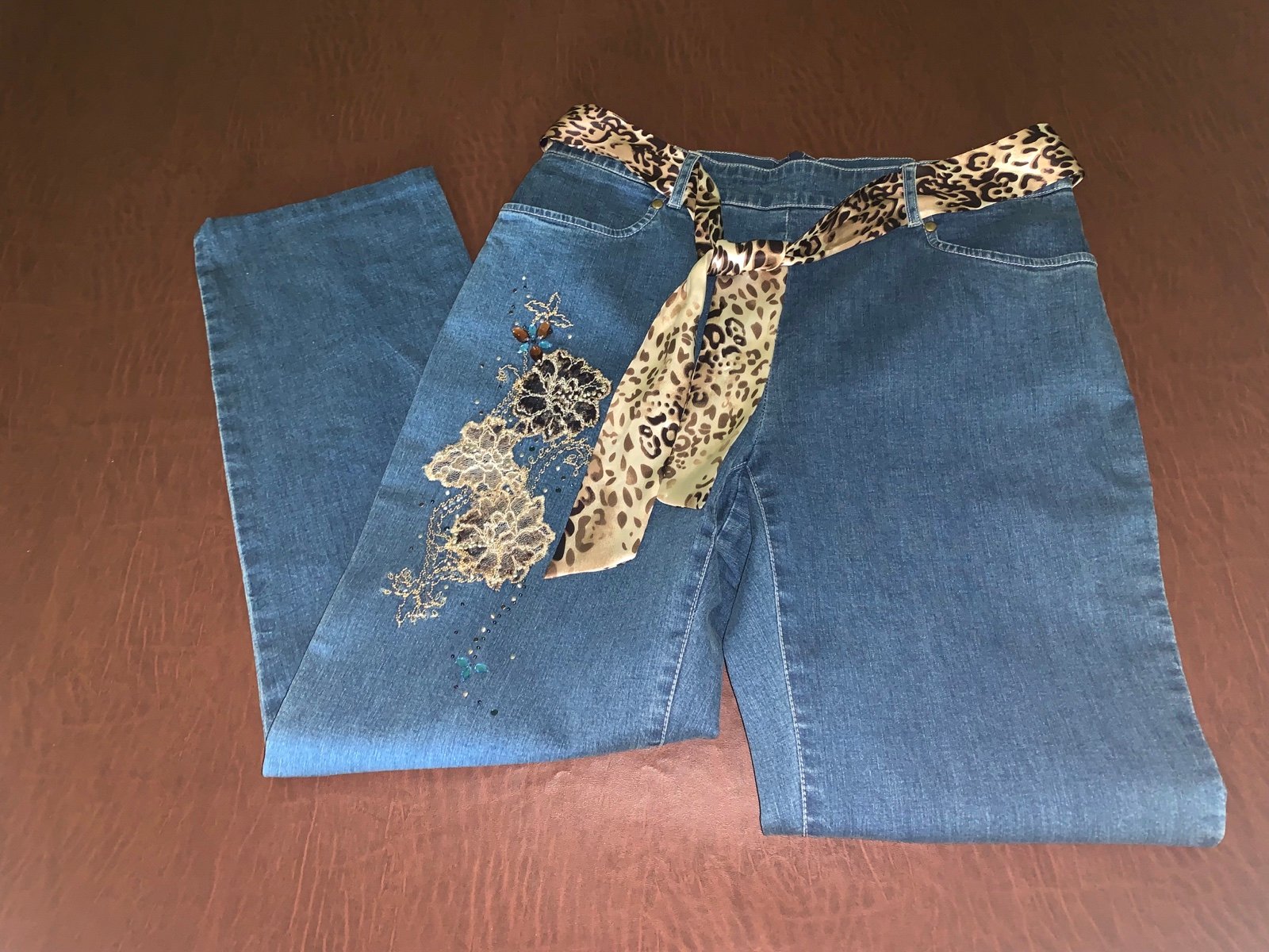 Nancy Bolen City Girl jeans with cheetah belt & embellishment to both pant legs