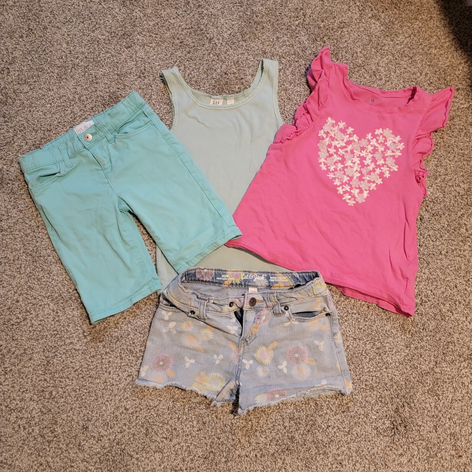 4 pieces- 2 shorts, Tank top, Ruffle shelvesless shirt.