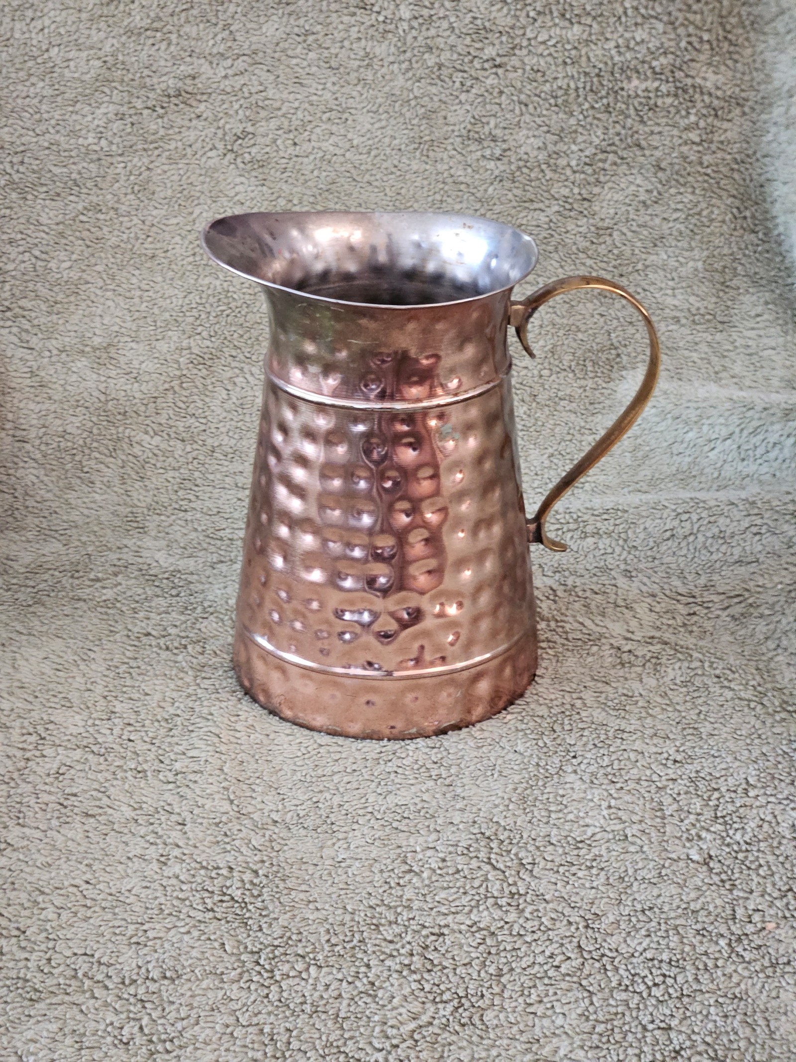 Antique hammered copper pitcher with brass handle