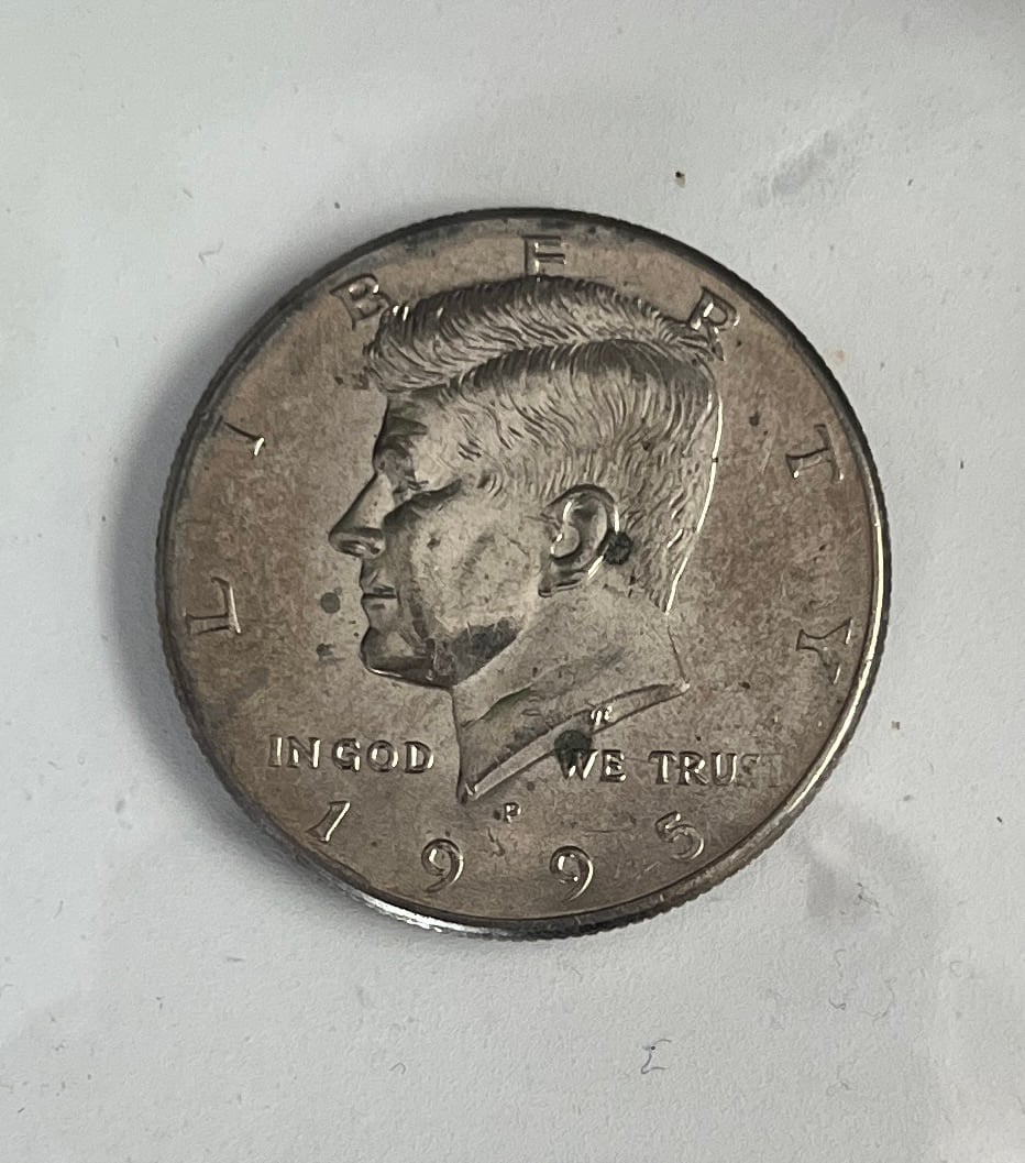 “In god we tru” strike error half dollar coin