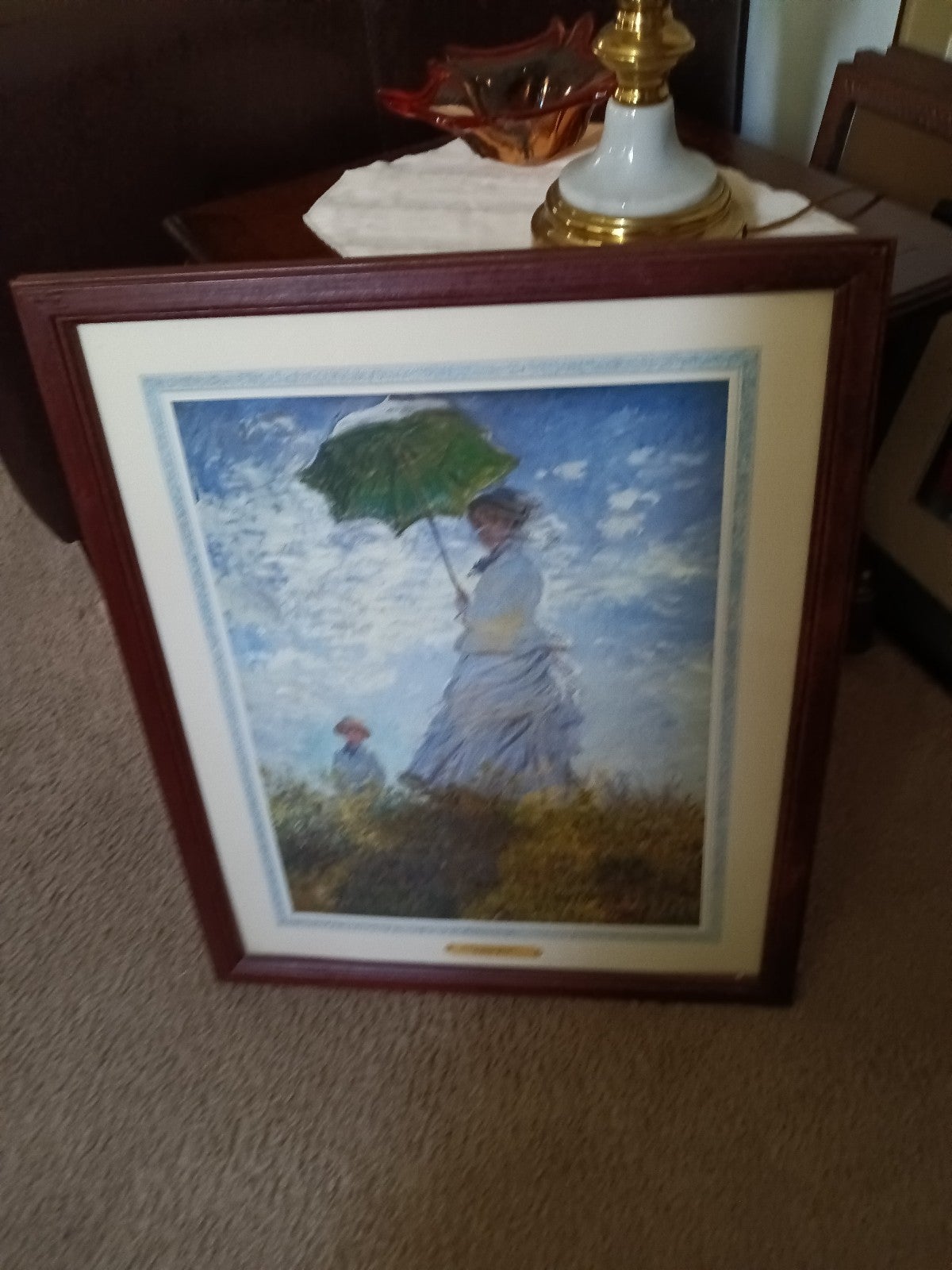 Framed print titled Woman With A Parasol by artist Claude Monet