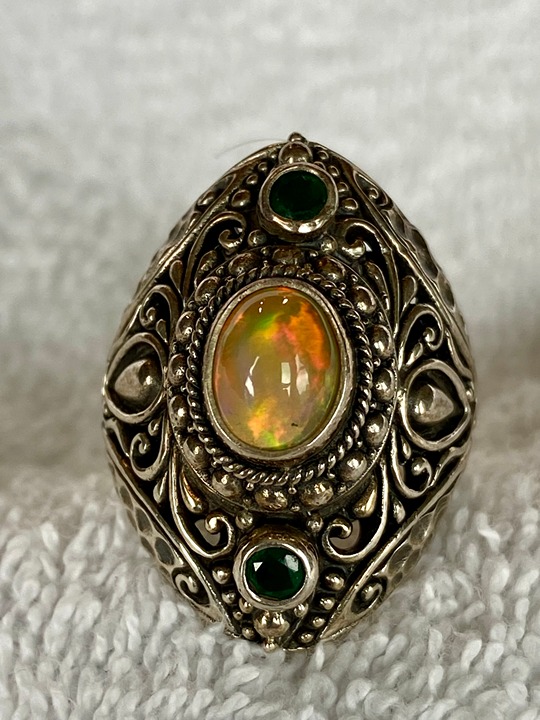SARDA 1.40CT OVAL ETHIOPIAN OPAL WITH 16CTW ROUND EMERALD SILVER RING. Size 7