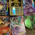 11 Pokémon tins with great cards, Pokémon sleeves, giant cards and more!!!! READ