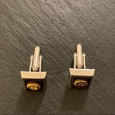 Vintage Anson Rotary International Silver Tone Cufflinks on Burgundy Background