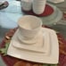 Elevate your dining experience with the Gibson Home Everyday Square White Cerami