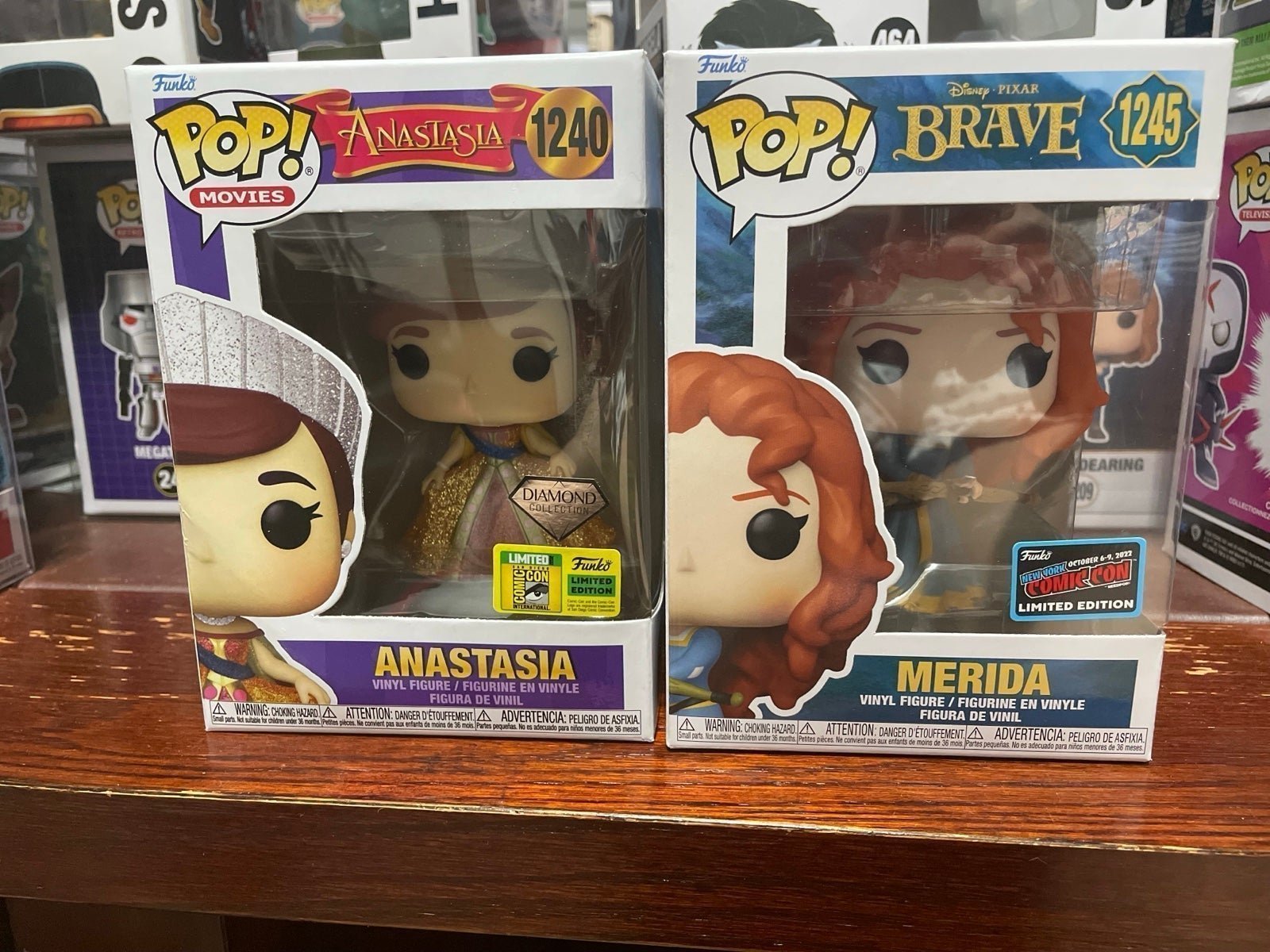 Merida and Anastasia funko pops con stickers