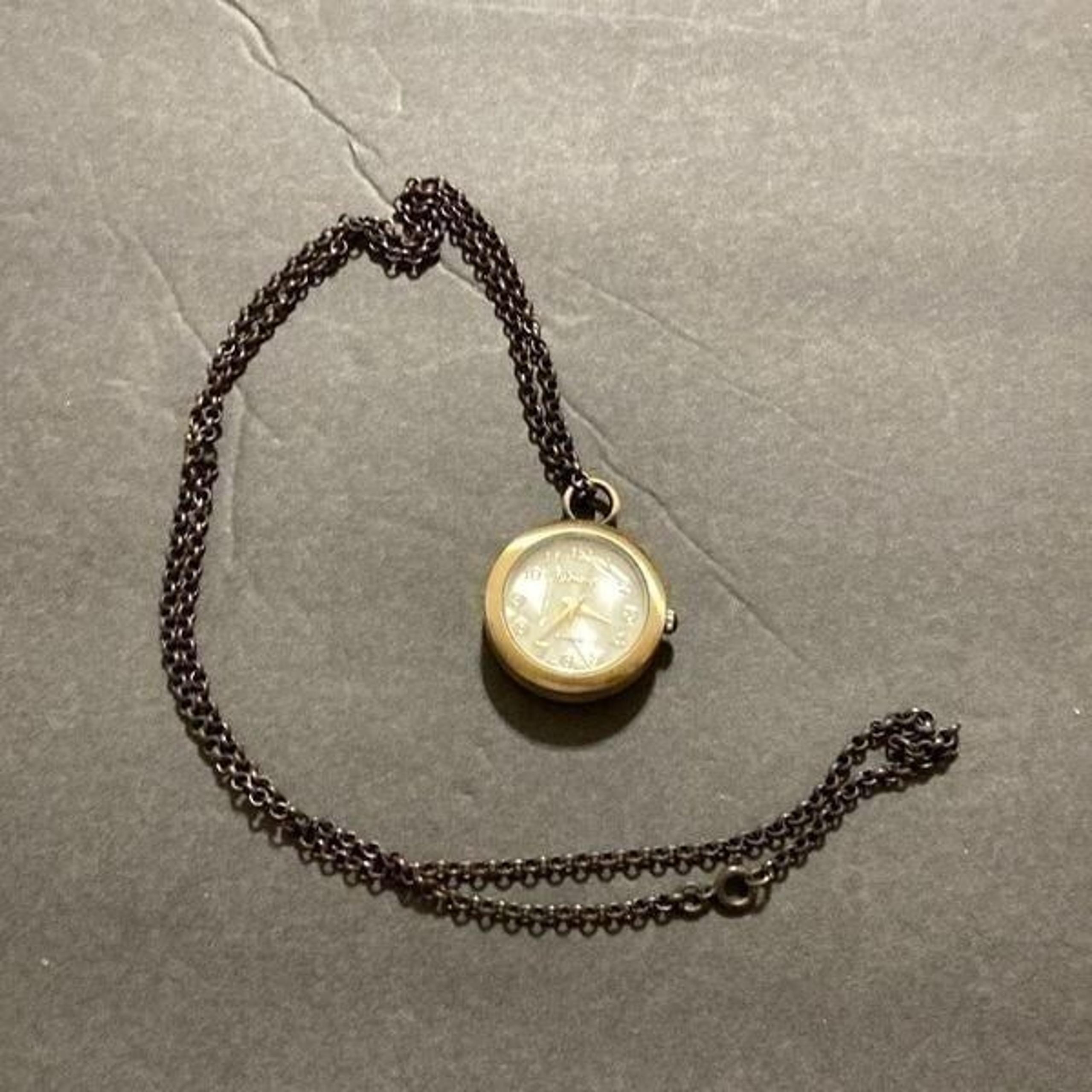 Geneva platinum watch pendant missing two stones